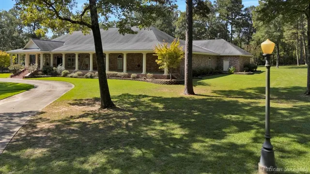 a view of a house with a yard patio and slide