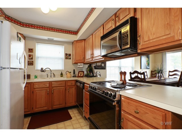 1844 Shetland Road Naperville, IL 60565 - Photo 3 of 10 a kitchen with stainless steel appliances granite countertop a sink stove and microwave
