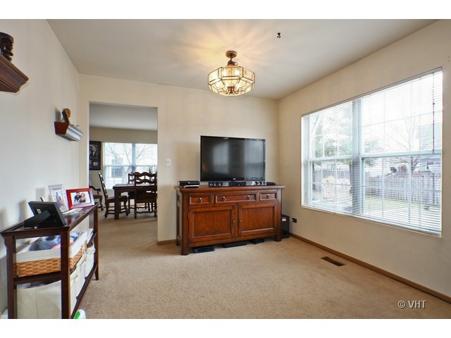 1844 Shetland Road Naperville, IL 60565 - Photo 4 of 10 a living room with furniture and a flat screen tv