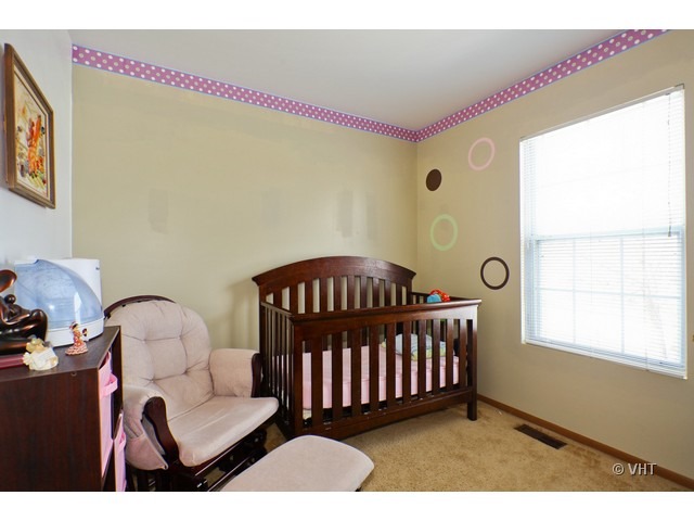 1844 Shetland Road Naperville, IL 60565 - Photo 7 of 10 a bedroom with a bed and a window