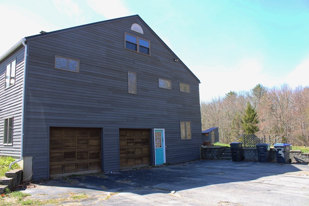 32 Hemlock Street Douglas, MA 01516 - Photo 3 of 41 a front view of a house with a yard