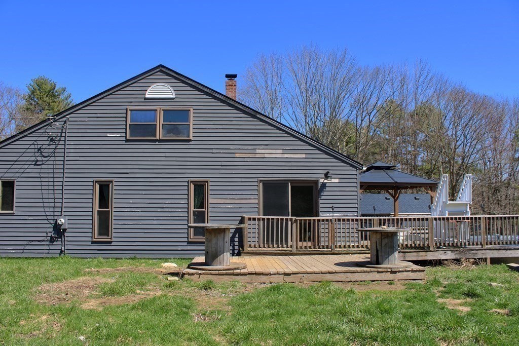 32 Hemlock Street Douglas, MA 01516 - Photo 32 of 41 a backyard of a house with seating space