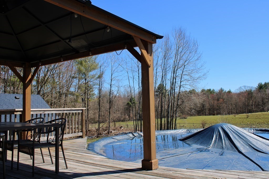 32 Hemlock Street Douglas, MA 01516 - Photo 33 of 41 a view of backyard with trees and wooden fence