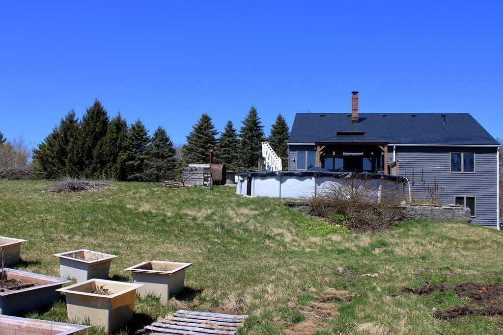 32 Hemlock Street Douglas, MA 01516 - Photo 34 of 41 a backyard of a house with table and chairs