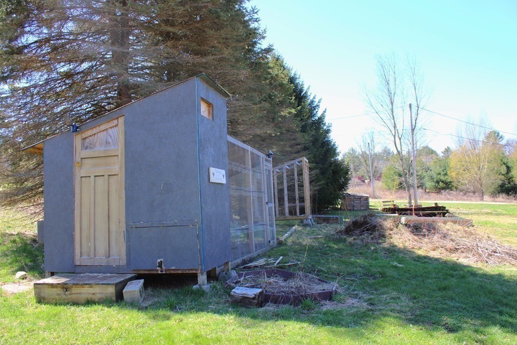 32 Hemlock Street Douglas, MA 01516 - Photo 38 of 41 a backyard of a house with table and chairs