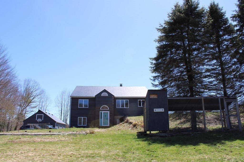32 Hemlock Street Douglas, MA 01516 - Photo 39 of 41 a view of a house with yard and a forest