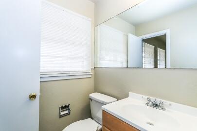 5408 31st Street Lubbock, TX 79407 - Photo 20 of 33 a bathroom with a sink mirror and toilet