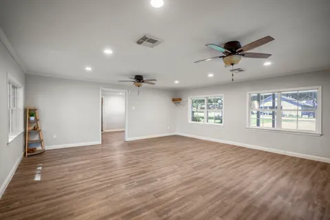 a living room with furniture a table and wooden floor