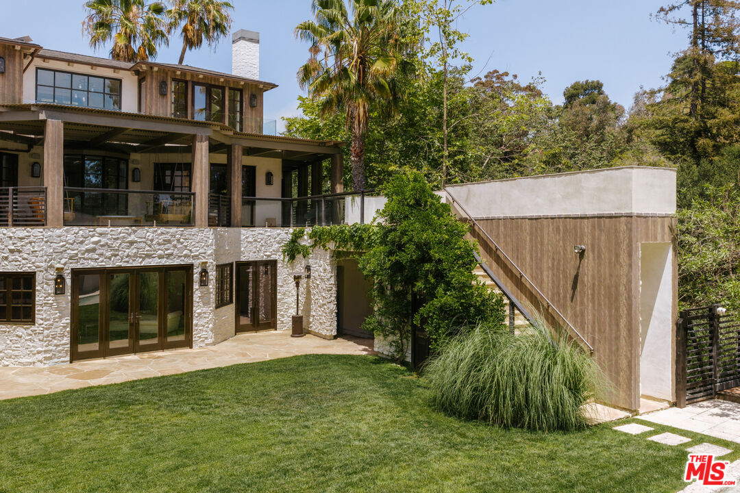1105 Rivas Canyon Road Pacific Palisades, CA 90272 - Photo 8 of 49 a view of a house with a yard and plants