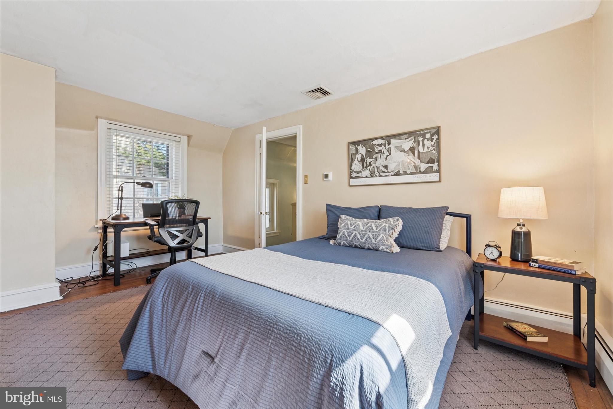 48 Old Eagle School Road Wayne, PA 19087 - Photo 22 of 33 a bedroom with a bed and a lamp on table