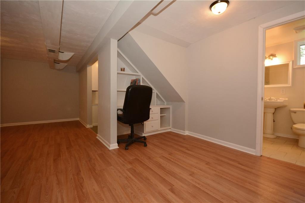 4158 Battle Ridge Road McDonald, PA 15057 - Photo 20 of 23 Tucked under the basement steps is a custom built desk with USB outlets for the latest equipment. To the right is a full bath with beautifully tiled shower.