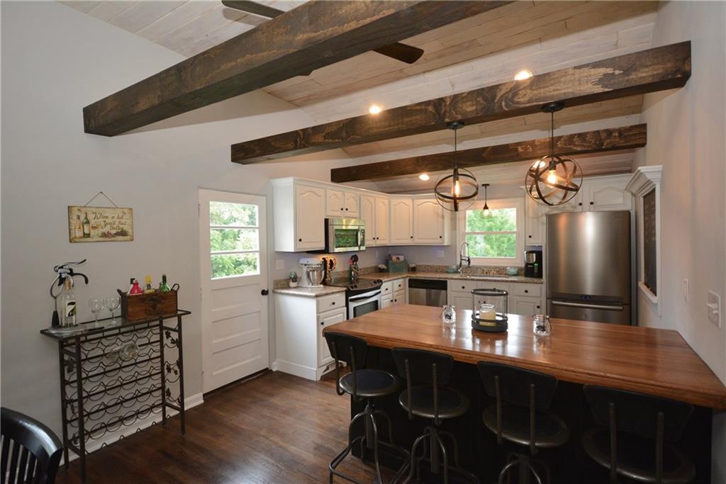 4158 Battle Ridge Road McDonald, PA 15057 - Photo 6 of 23 This kitchen is open to the living room and dining room with granite counter tops, stainless steel appliances and original refinished hardwood floors.