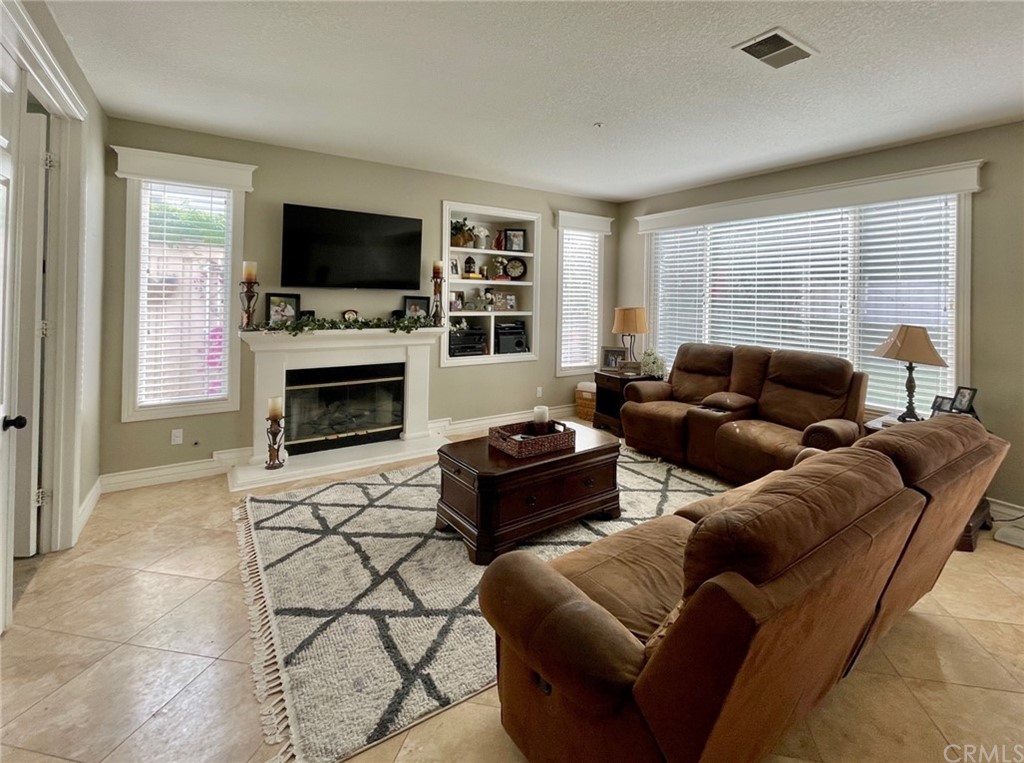 808 Carnaros San Clemente, CA 92672 - Photo 4 of 17 a living room with furniture a flat screen tv and a fireplace