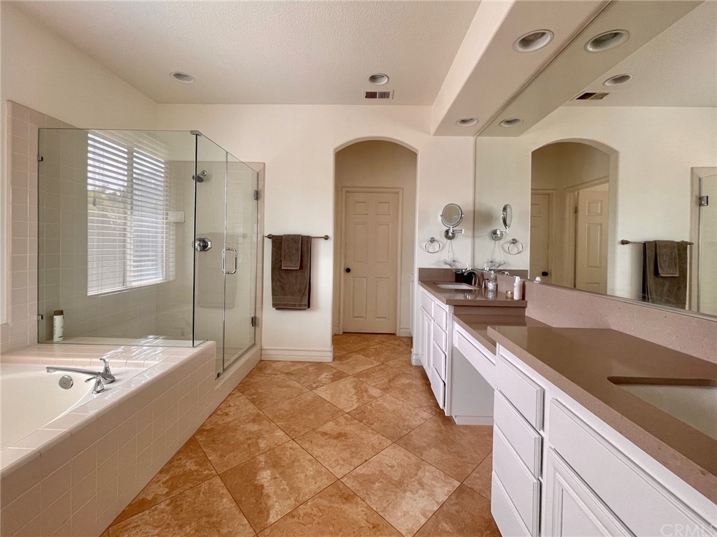 808 Carnaros San Clemente, CA 92672 - Photo 10 of 17 a large bathroom with a granite countertop tub a double vanity sink and a large mirror