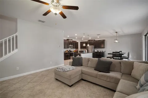 a kitchen with stainless steel appliances granite countertop a sink a stove and a refrigerator