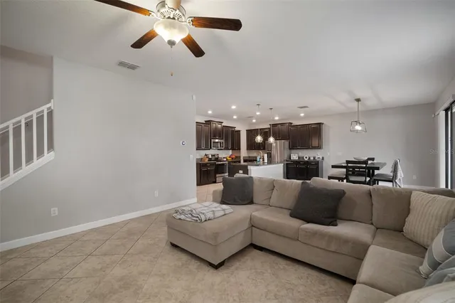 a kitchen with stainless steel appliances granite countertop a sink a stove and a refrigerator