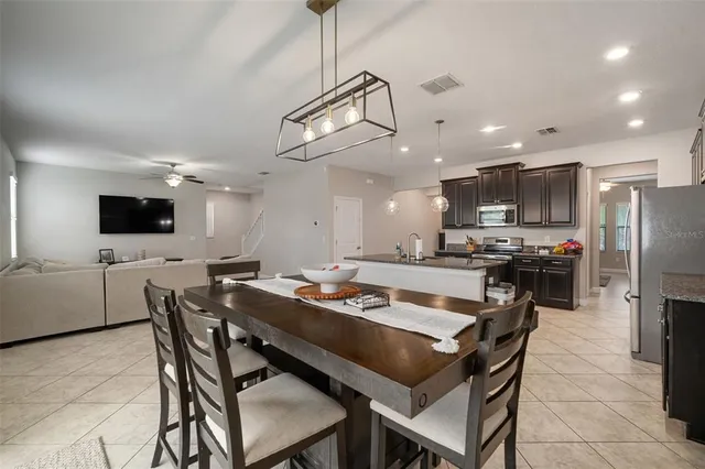 a kitchen with refrigerator and cabinets