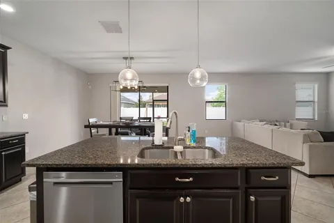 a bedroom with a bed a dresser and flat screen tv