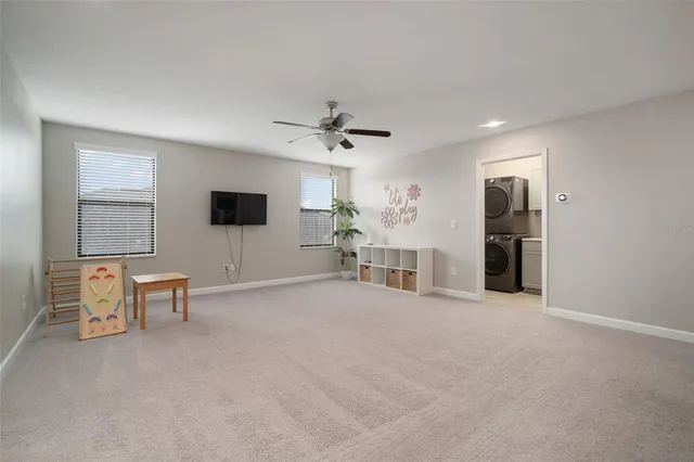 a bedroom with a bed and a ceiling fan