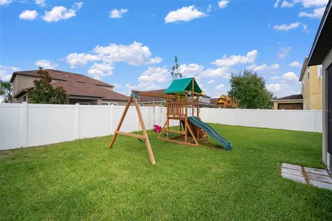 a front view of a house with garden and sitting area