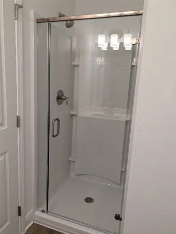 a bathroom with a glass shower door