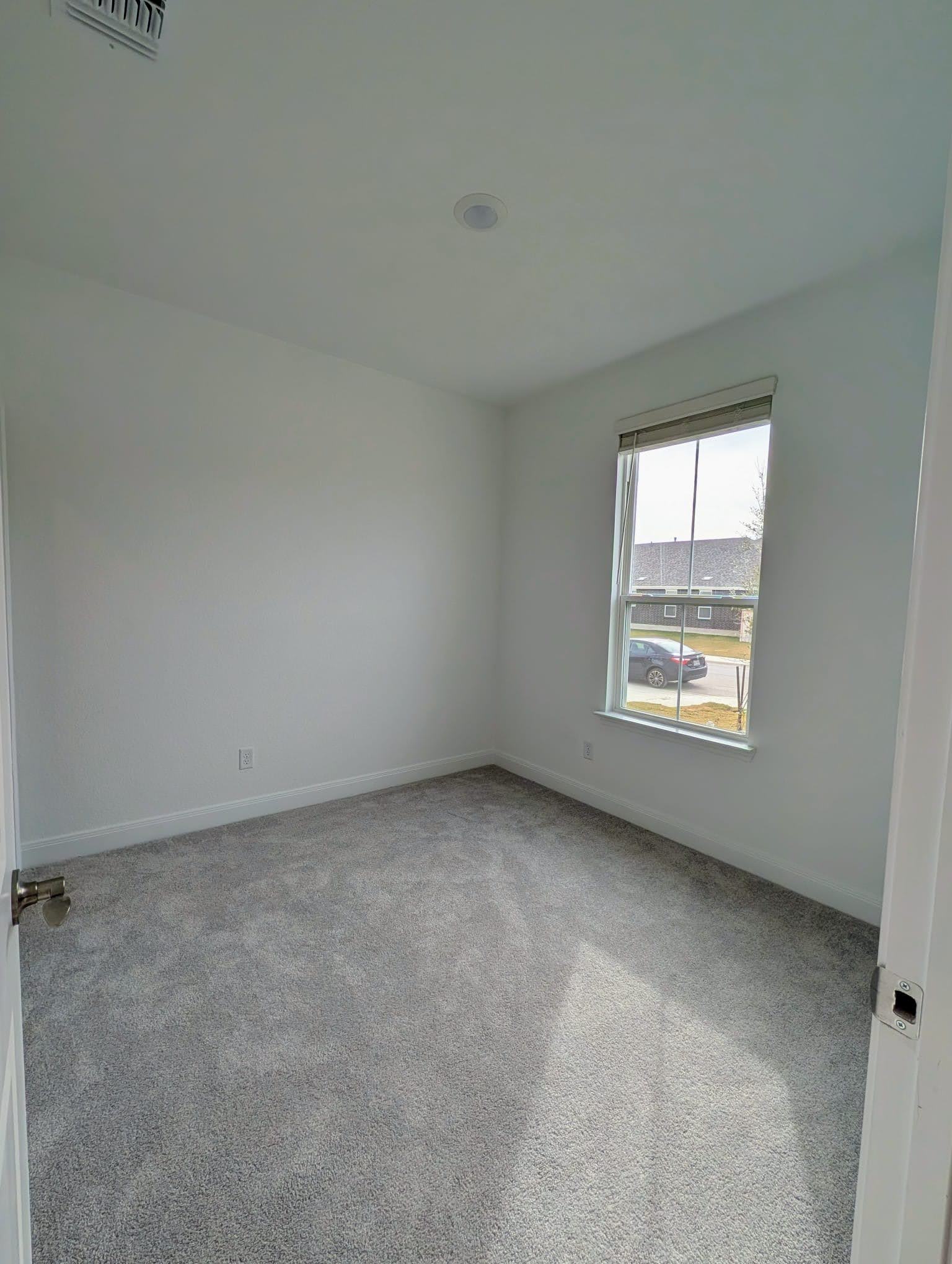 212 Daniels Dusty Trail Georgetown, TX 78626 - Photo 5 of 23 Spare room with light colored carpet and baseboards