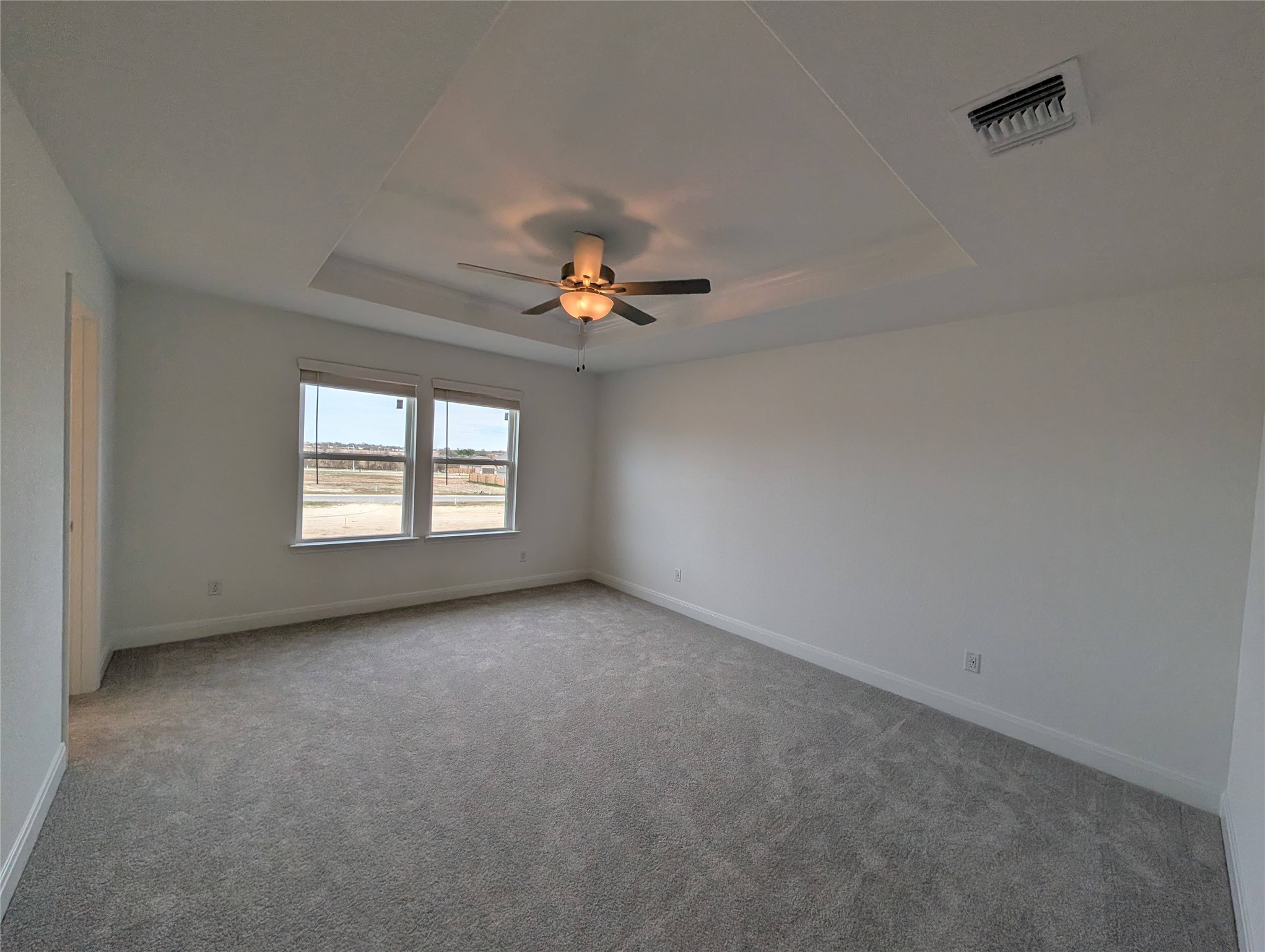 212 Daniels Dusty Trail Georgetown, TX 78626 - Photo 10 of 23 Carpeted empty room with a tray ceiling and a ceiling fan