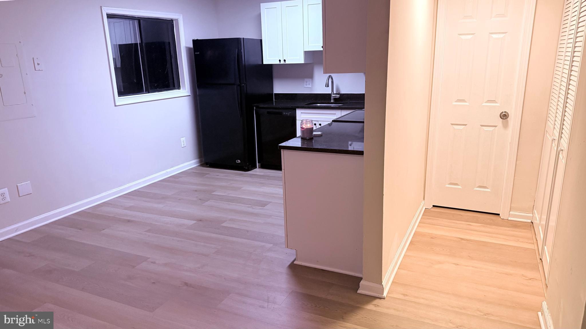 1287 Springtide Place Herndon, VA 20170 - Photo 9 of 23 a kitchen with granite countertop a refrigerator and a stove top oven