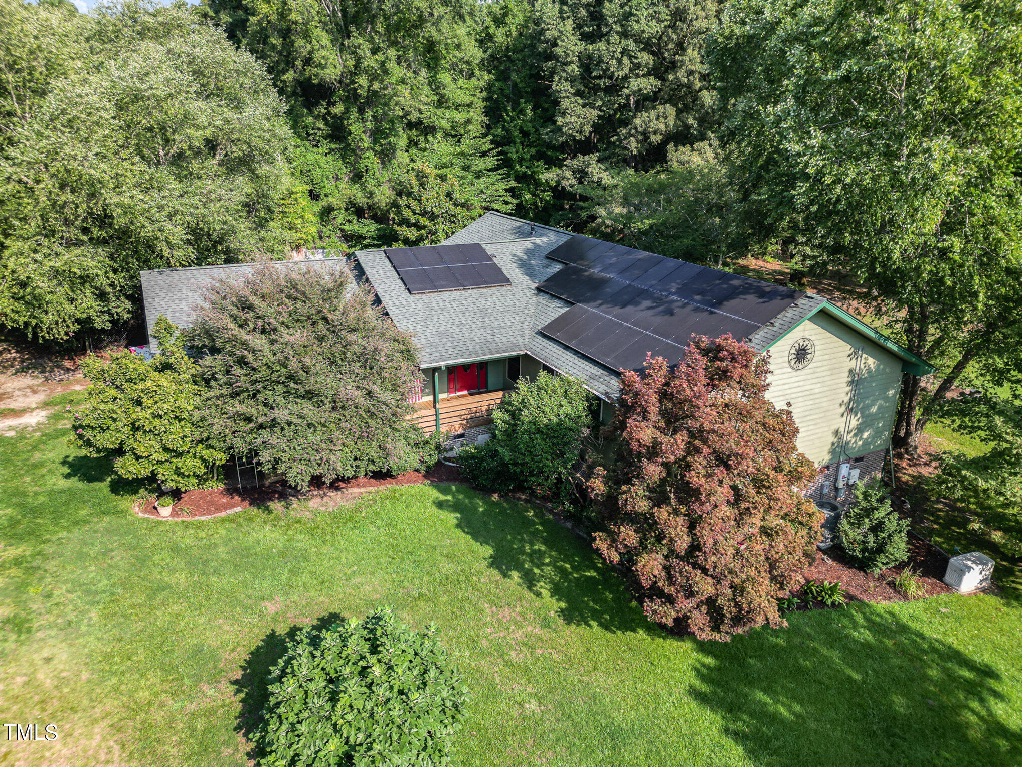 a view of a house with a yard and garden