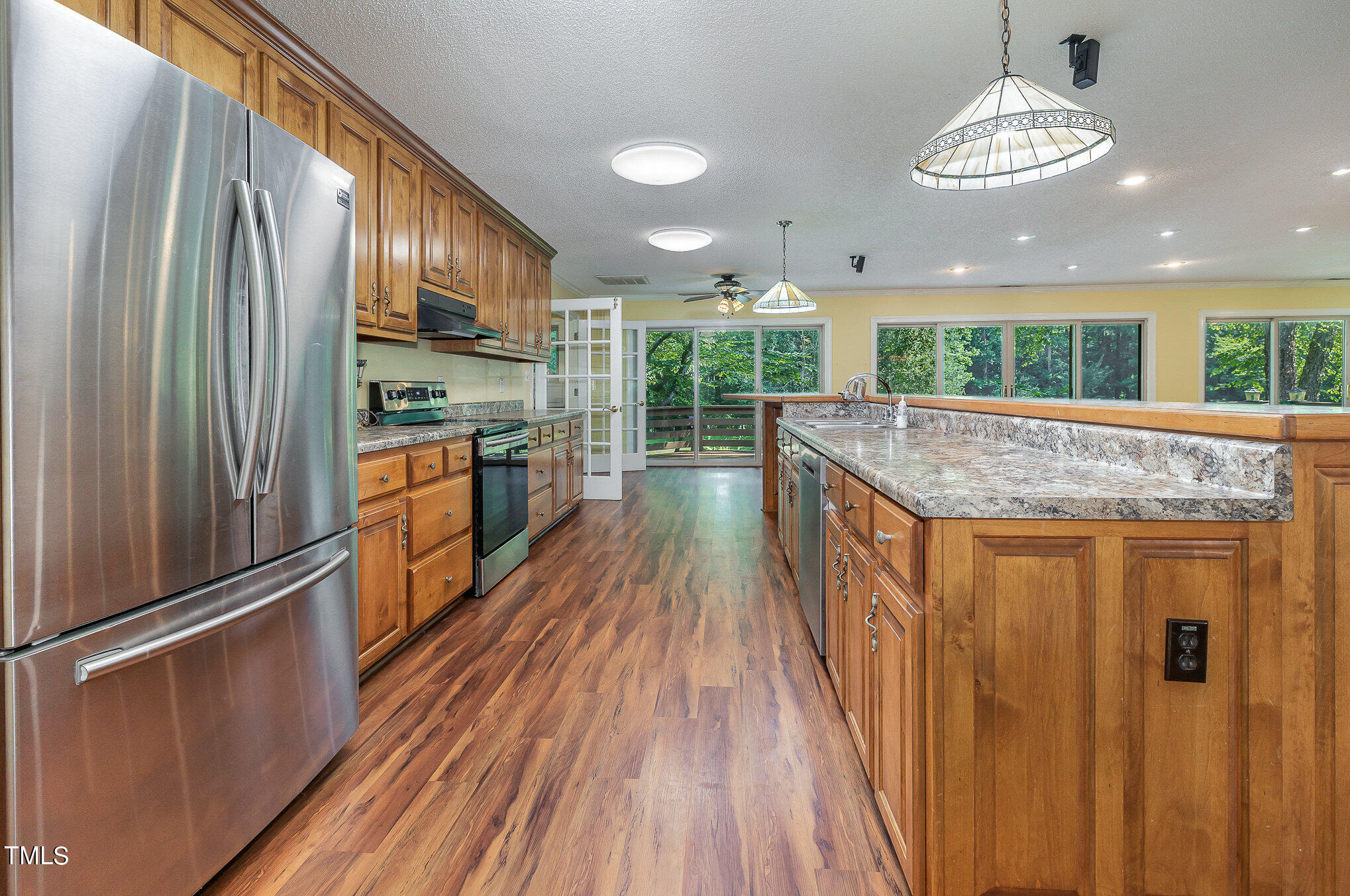 2887 Micro Road West Selma, NC 27576 - Photo 16 of 48 a kitchen with stainless steel appliances granite countertop a refrigerator a stove and a wooden floors