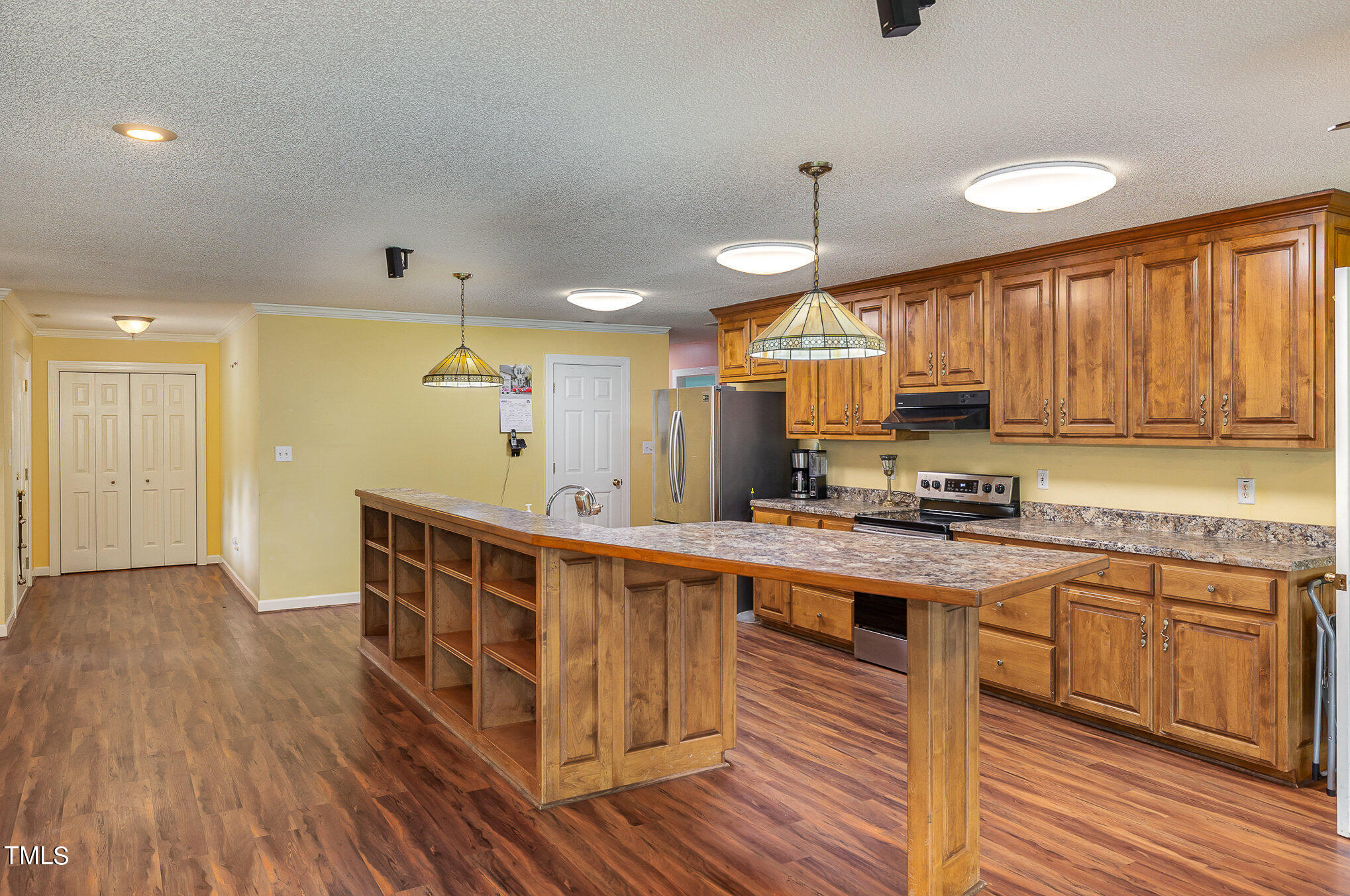 2887 Micro Road West Selma, NC 27576 - Photo 17 of 48 a kitchen with stainless steel appliances a sink and wooden cabinets