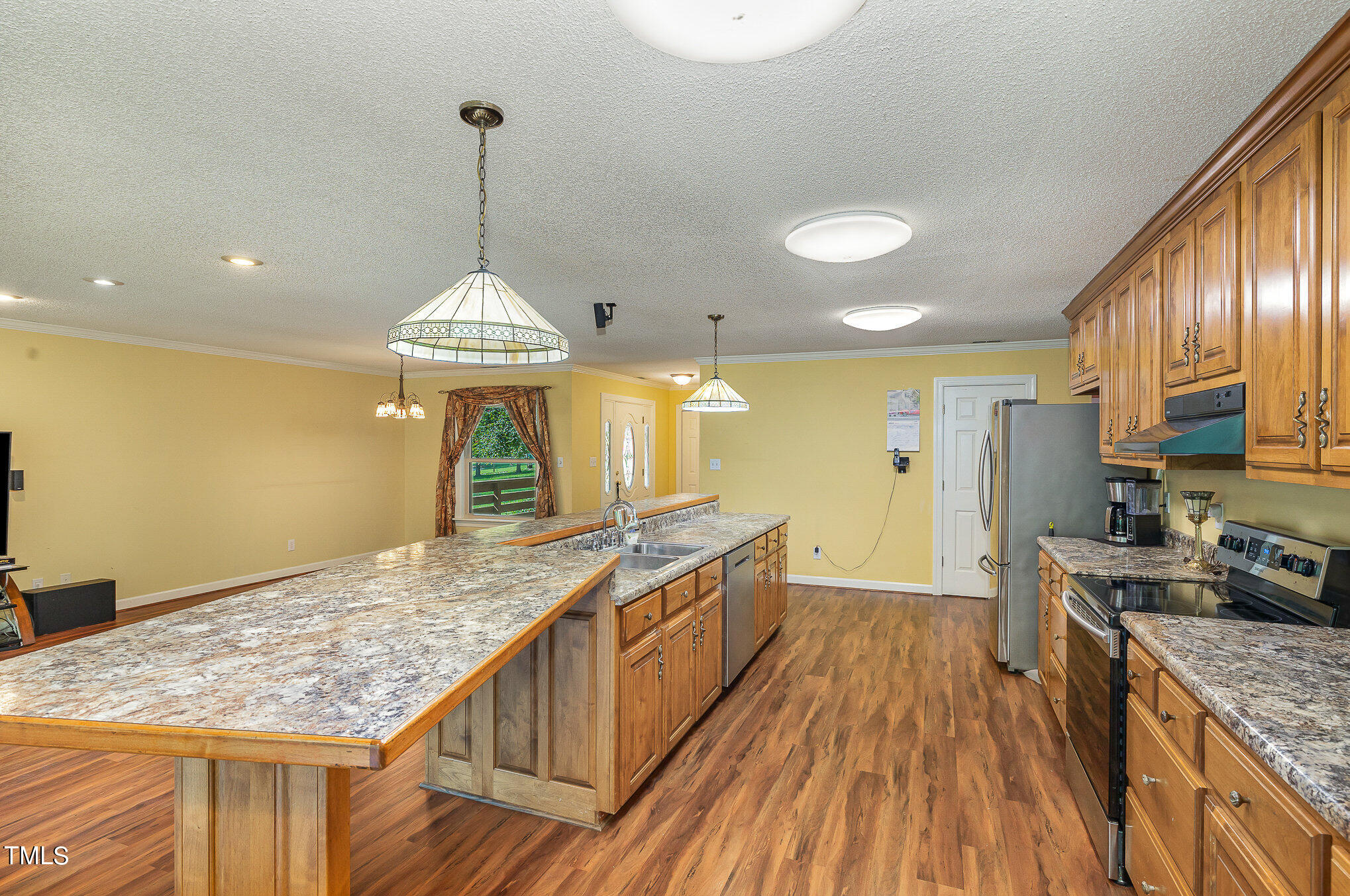 2887 Micro Road West Selma, NC 27576 - Photo 19 of 48 a kitchen with stainless steel appliances granite countertop a stove oven and a wooden floors