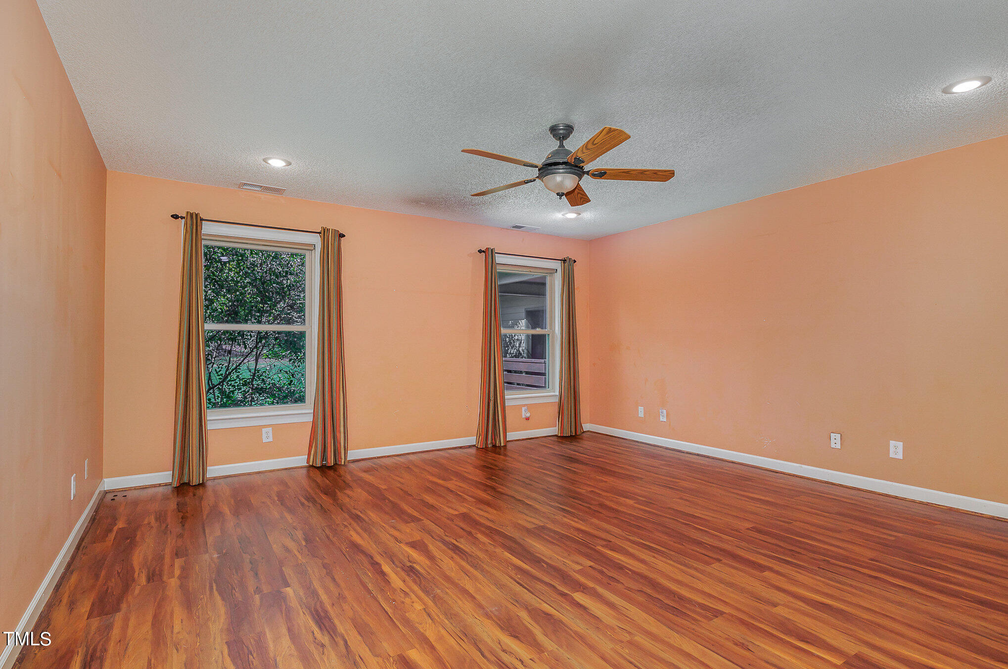 2887 Micro Road West Selma, NC 27576 - Photo 22 of 48 a view of an empty room with wooden floor and a window