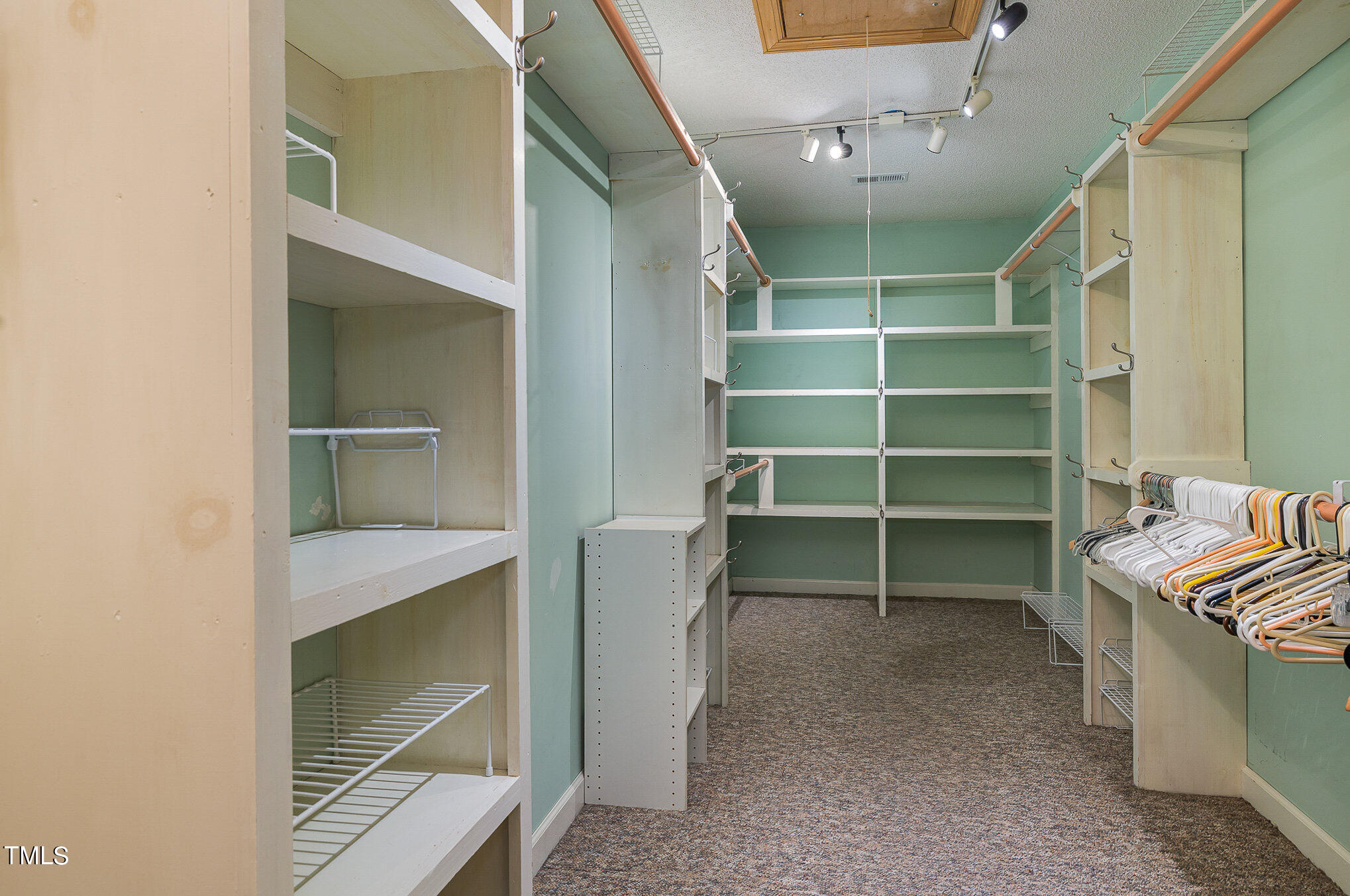 2887 Micro Road West Selma, NC 27576 - Photo 25 of 48 a view of walk in closet with empty racks