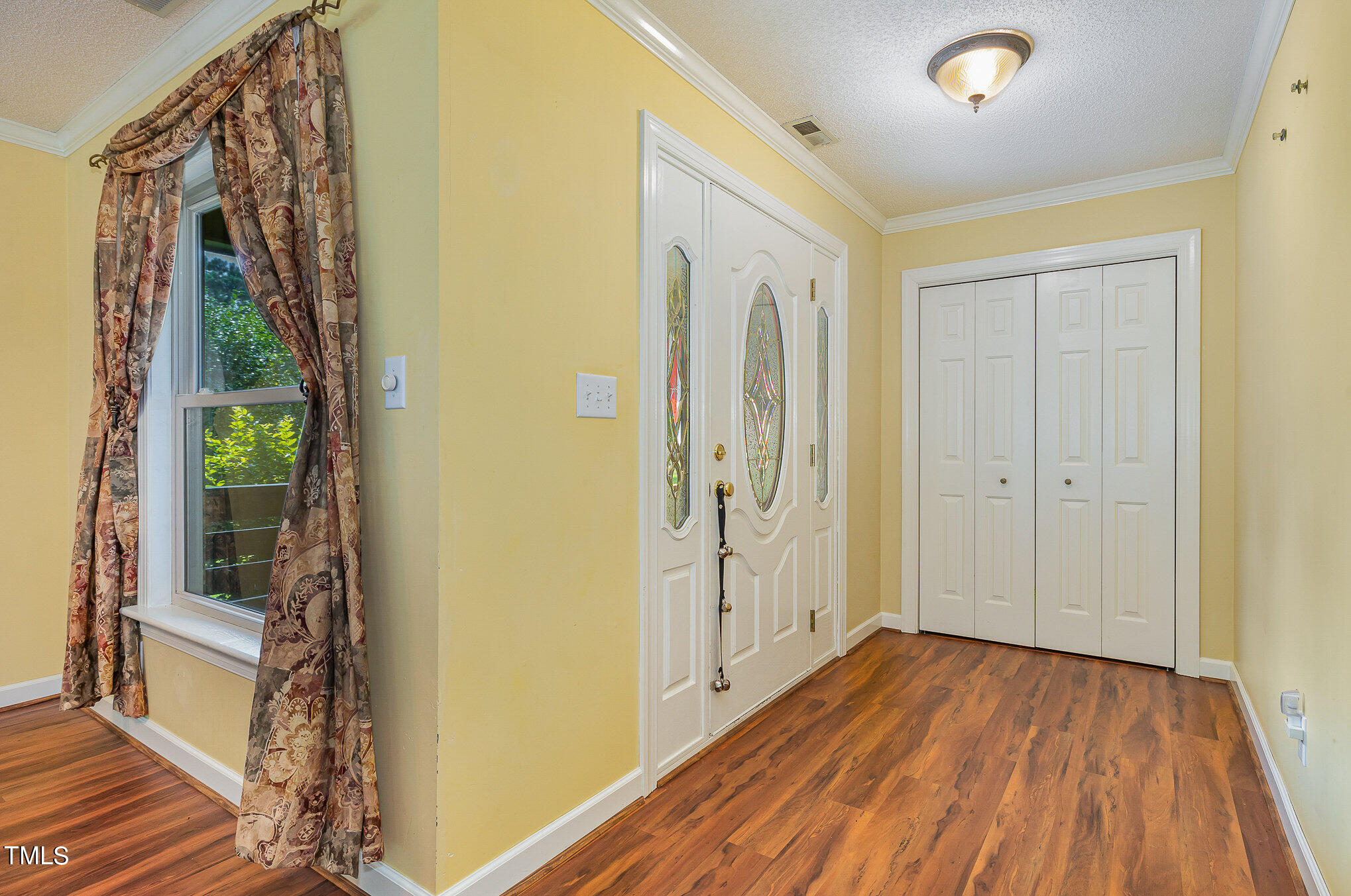 2887 Micro Road West Selma, NC 27576 - Photo 6 of 48 a view of a hallway with wooden floor and stairs
