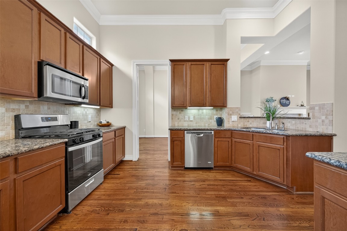 5938 Kansas Street Houston, TX 77007 - Photo 11 of 30 a kitchen with stainless steel appliances granite countertop a stove a sink and a microwave