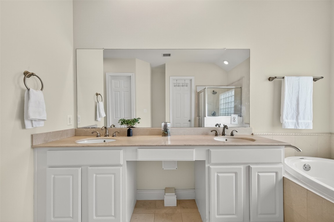 5938 Kansas Street Houston, TX 77007 - Photo 12 of 30 a bathroom with a double vanity sink and mirror