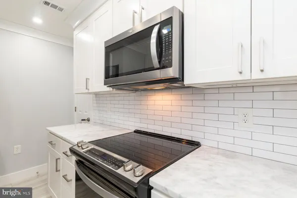 a kitchen with a stove and a microwave