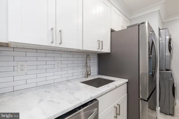 a kitchen with stainless steel appliances a refrigerator and a sink