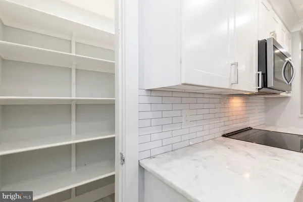a view of kitchen cabinets and microwave