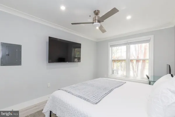 a bedroom with a large bed and a flat screen tv