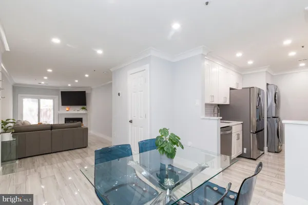 a kitchen with stainless steel appliances granite countertop a refrigerator oven a sink dishwasher and a refrigerator with wooden floor