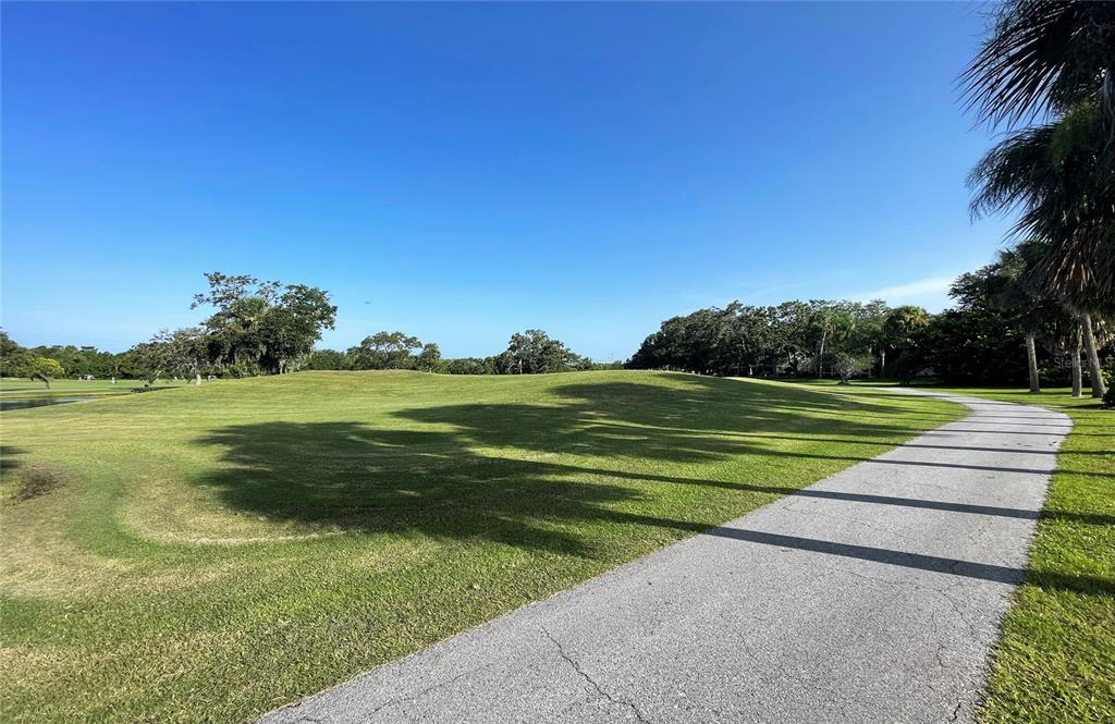 700 Starkey Road, Unit 1145 Largo, FL 33771 - Photo 50 of 63 a view of a golf course with a lake