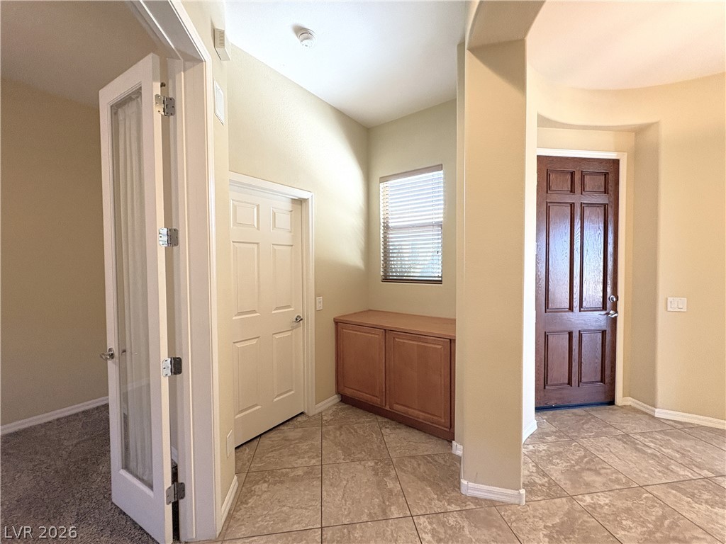 10 Caprington Road Henderson, NV 89052 - Photo 25 of 44 A welcoming entry area with varied flooring and warm tones awaits new residents.