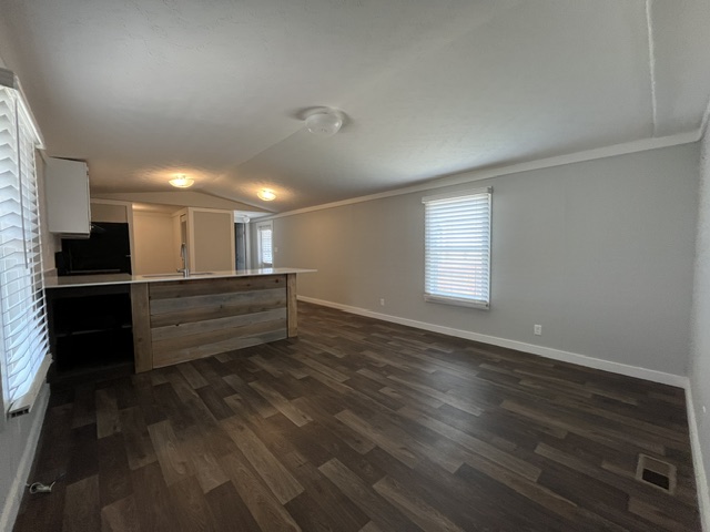 121 Sunflower Road Dale, TX 78616 - Photo 2 of 15 An open concept design seamlessly connects the well-appointed kitchen to the adjacent living area.