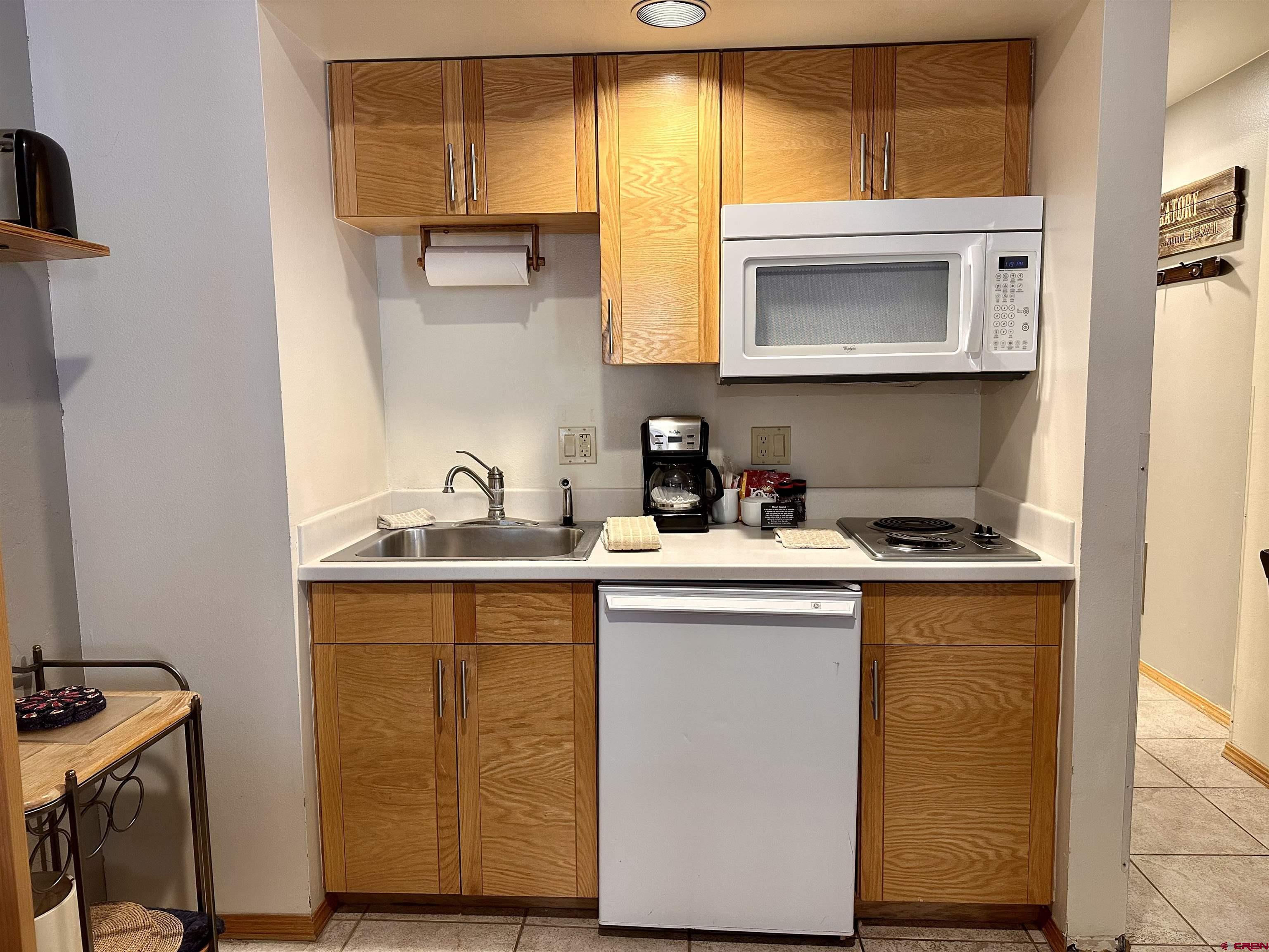 71 Needles Way, Unit 441 Durango, CO 81301 - Photo 12 of 39 a kitchen with stainless steel appliances granite countertop a sink and a microwave