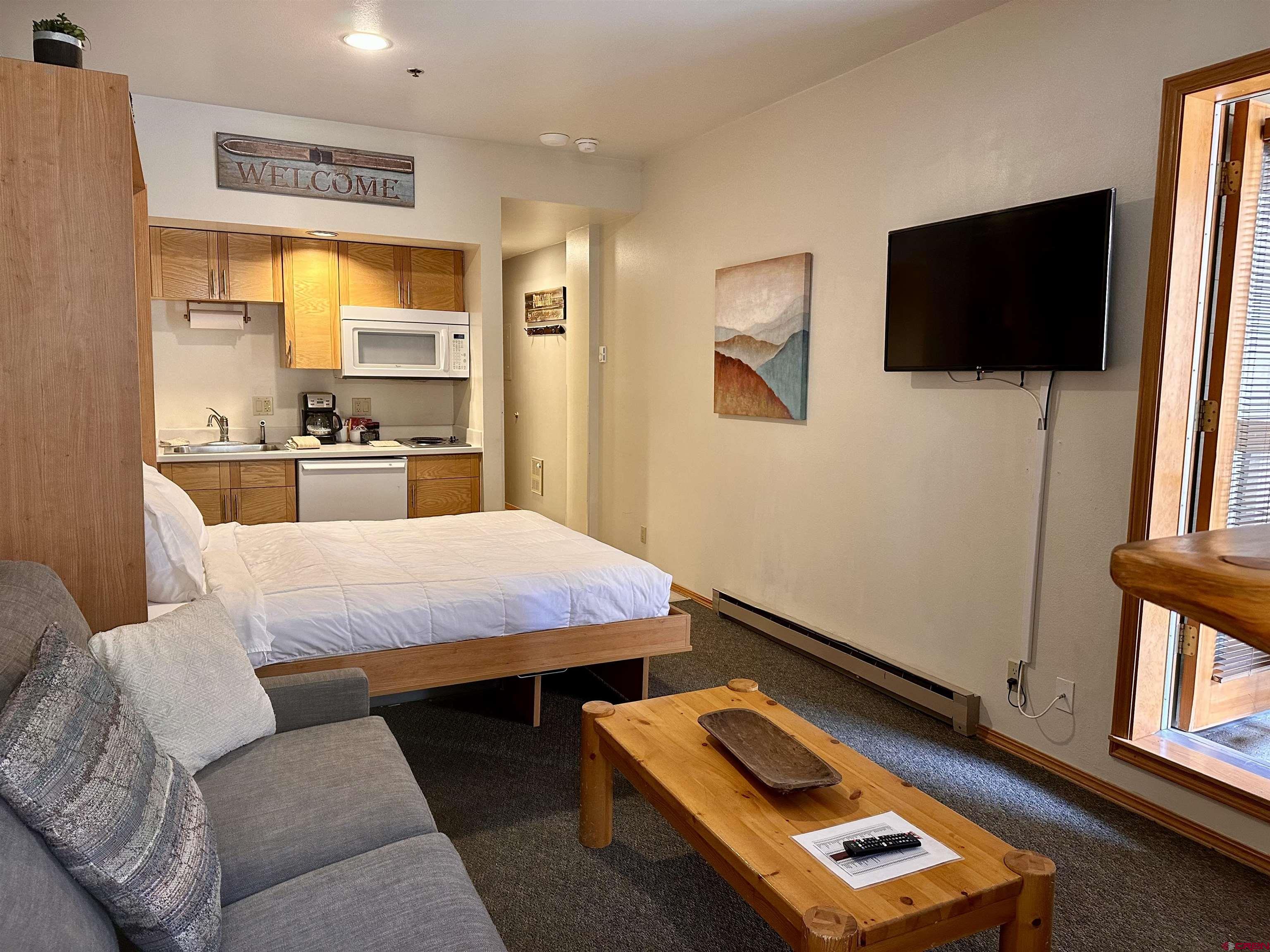 71 Needles Way, Unit 441 Durango, CO 81301 - Photo 14 of 39 a room with furniture and a flat screen tv