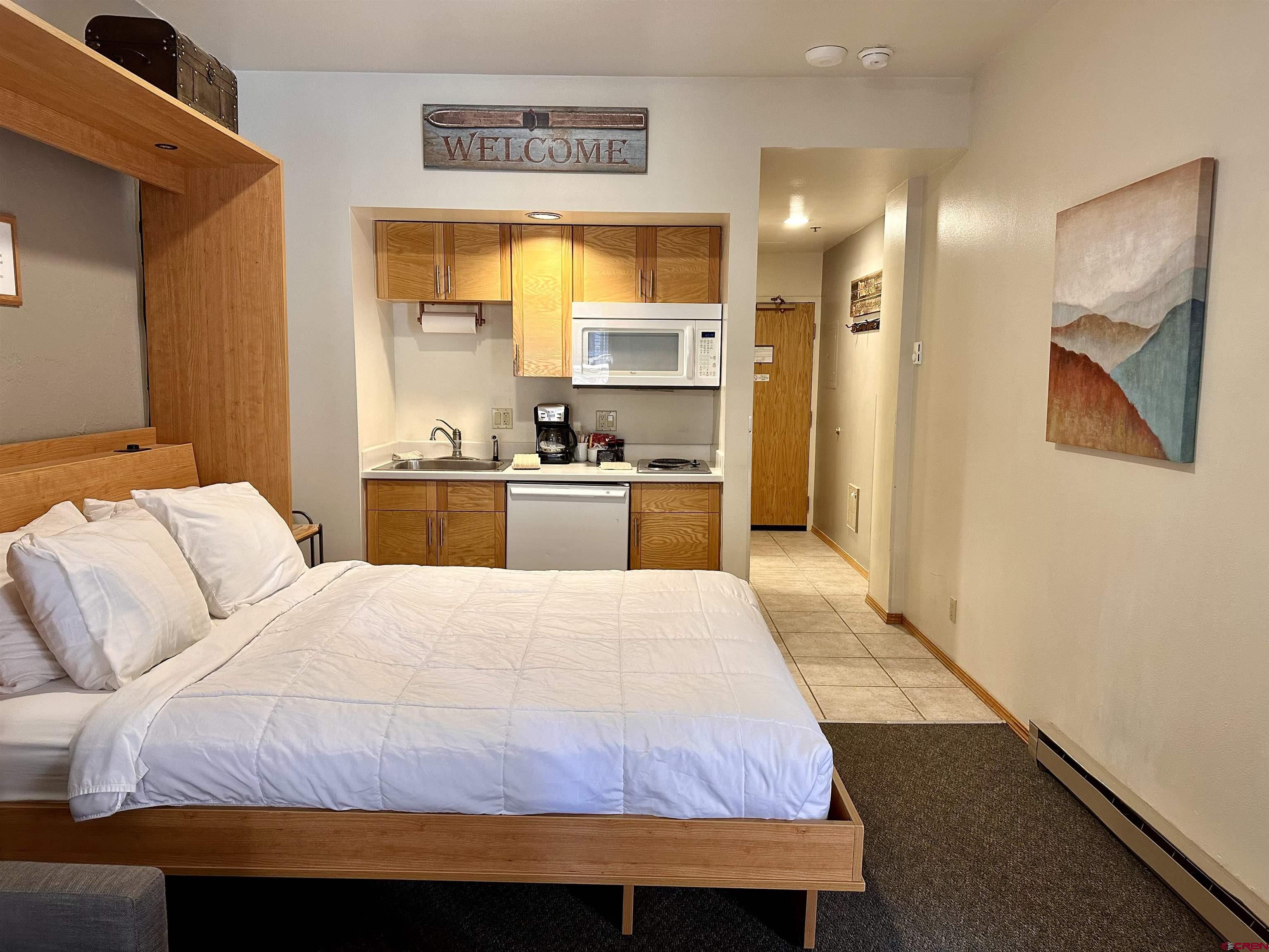 71 Needles Way, Unit 441 Durango, CO 81301 - Photo 15 of 39 a bedroom with a bed and a view of kitchen