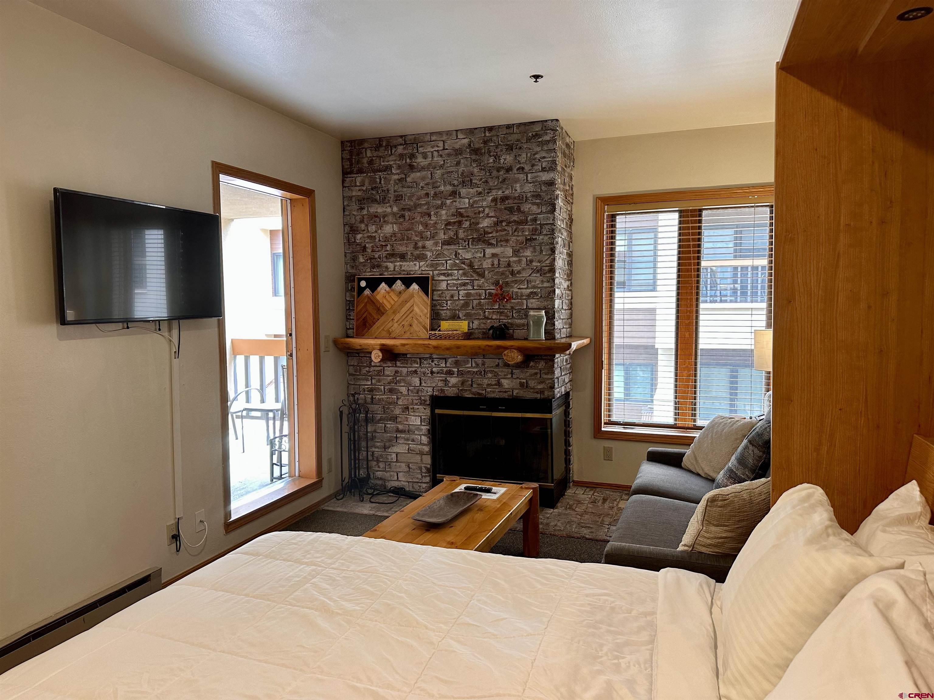71 Needles Way, Unit 441 Durango, CO 81301 - Photo 17 of 39 a bedroom with a bed and a fireplace