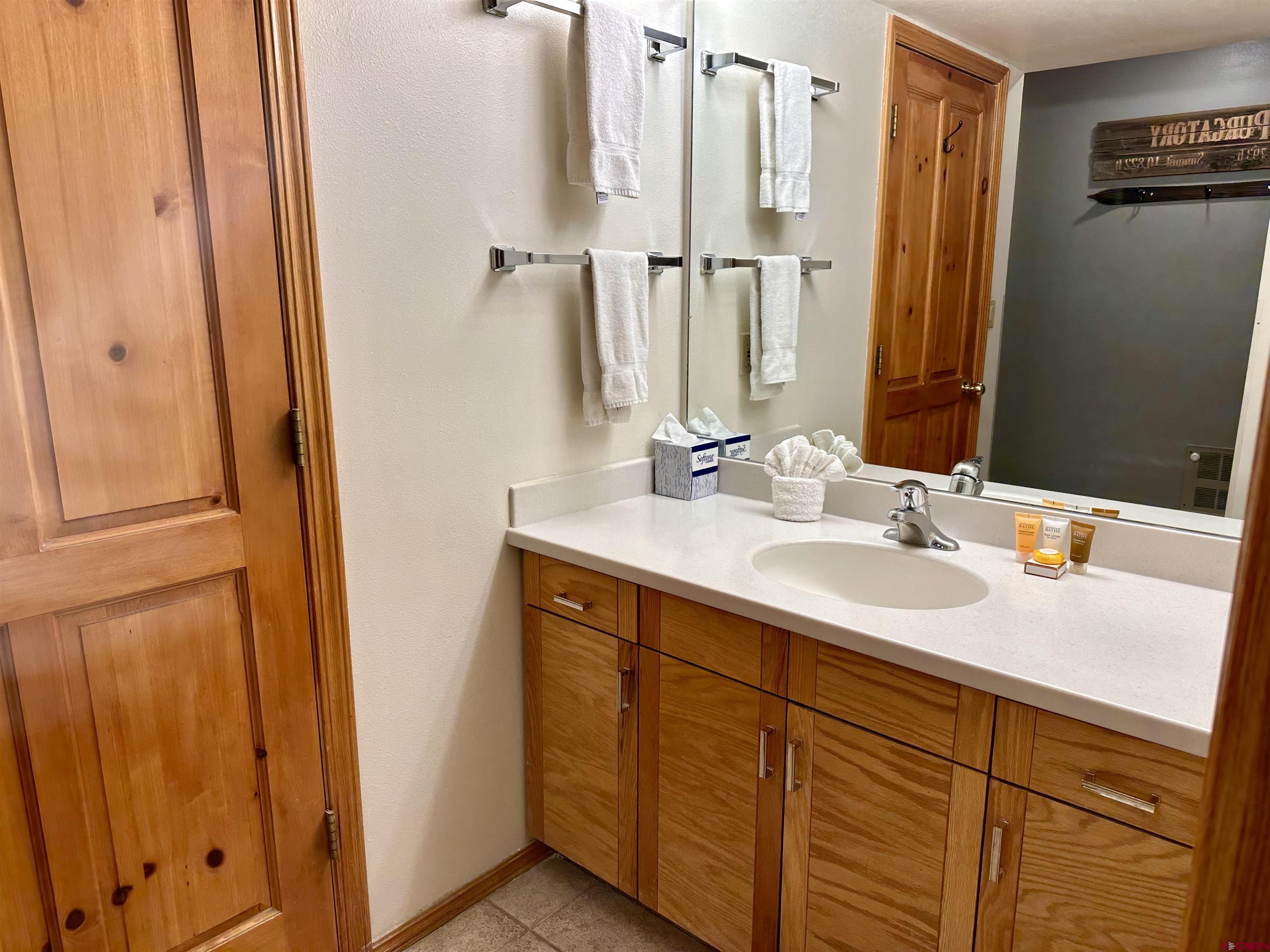 71 Needles Way, Unit 441 Durango, CO 81301 - Photo 19 of 39 a bathroom with a double vanity sink and a mirror